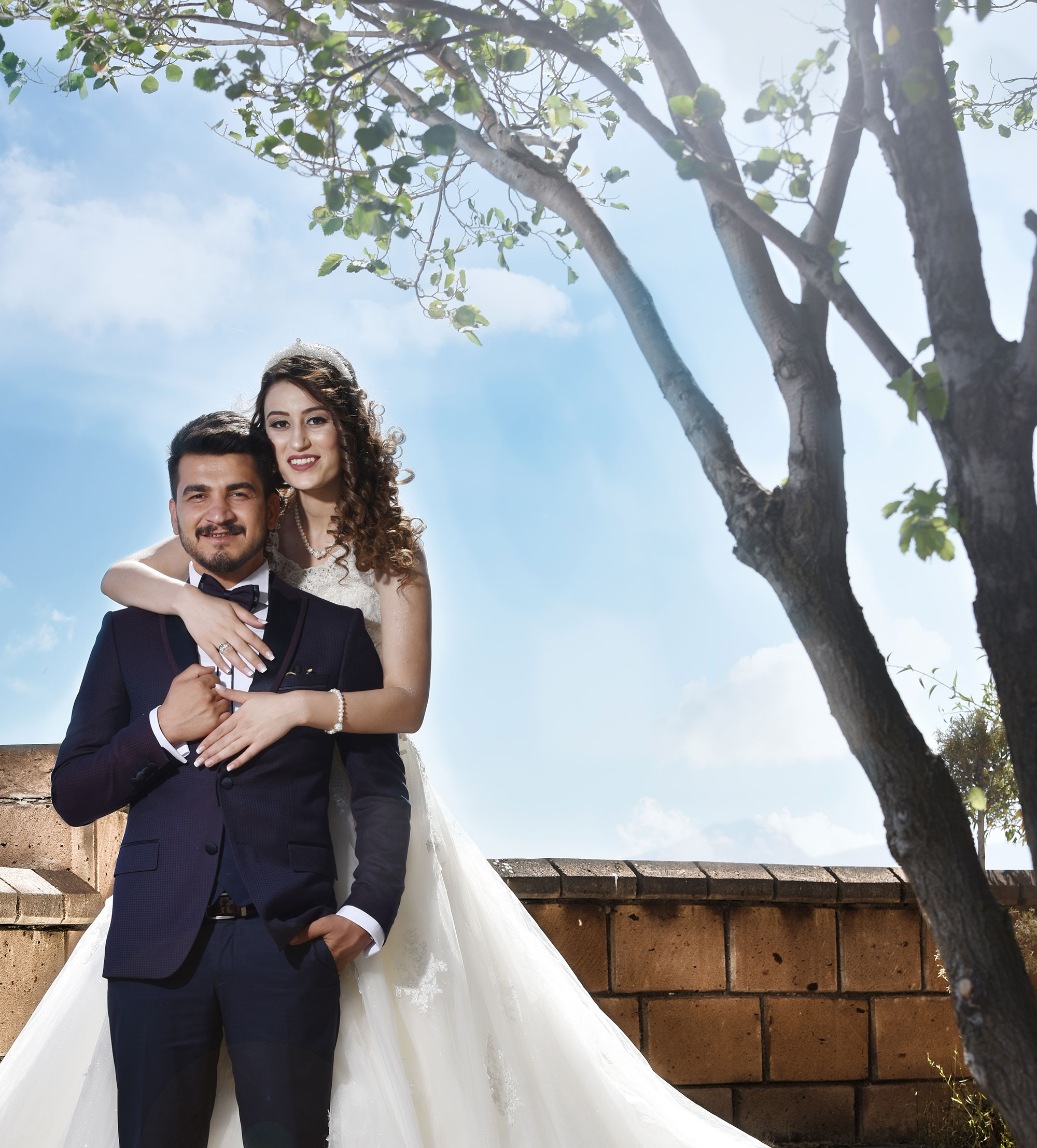Bride and groom by a tree